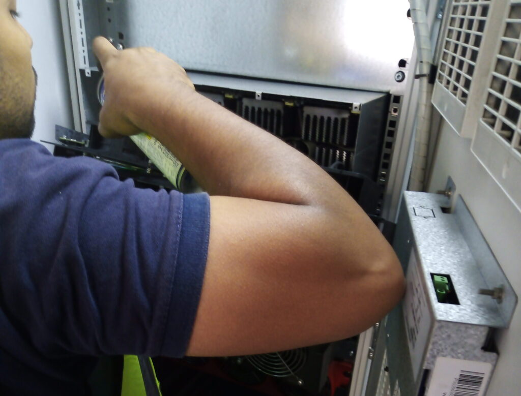 Technician performing preventive maintenance on a UPS system, ensuring reliability and maximizing performance with DEWEN®’s Preventive Maintenance Service Plan.